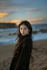 a woman standing on top of a sandy beach