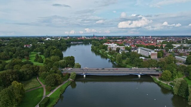 An aerial drone view of Aasee Lake in M&uuml;nster . Lake Aasee is an artificial lake located in M&uuml;nster , Germany .