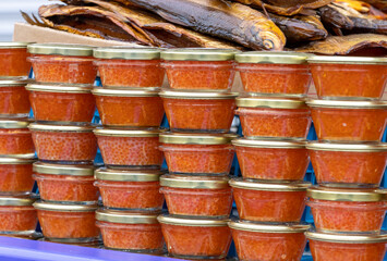 Yellow orange fish roe caviar in glass jar