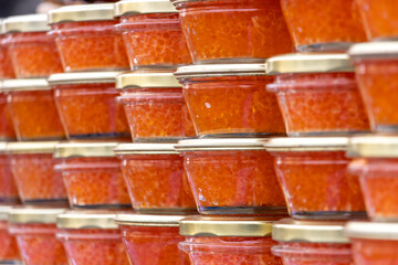 Yellow orange fish roe caviar in glass jar