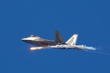 Side view of a F-22 Raptor deploying a flare