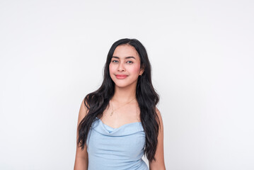 Young woman in a baby blue dress smiling, isolated on white background - obrazy, fototapety, plakaty