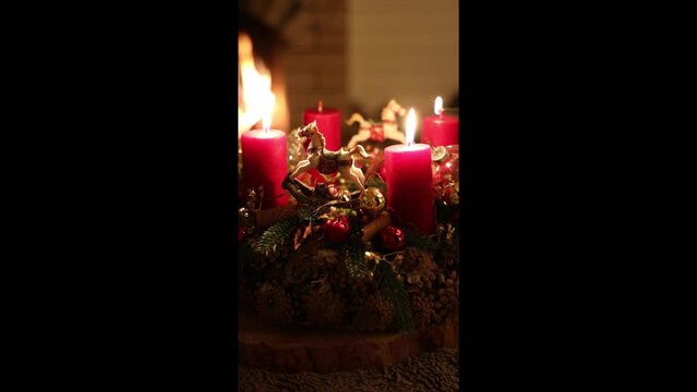 christmas evening by the fireplace lighting candles
