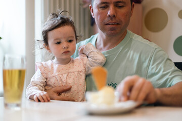 Portrait of a caucasian father with his daughter in a cafe.