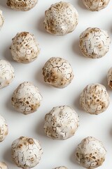 multiple white truffles, isolated on a stark white backdrop, topdown view