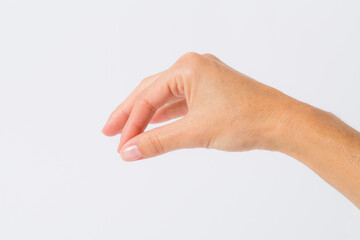 A woman's hand taking something between her fingers