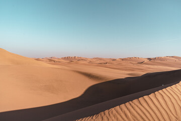 sand dunes in the desert at sunset