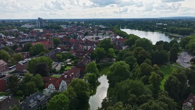 An aerial drone view of Aasee Lake in M&uuml;nster . Lake Aasee is an artificial lake located in M&uuml;nster , Germany .