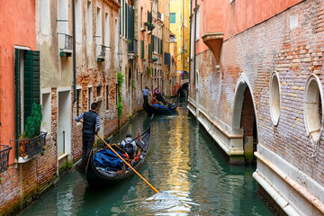 Narrow canal with gondola in Venice, Italy. Architecture and landmark of Venice. Cozy cityscape of...