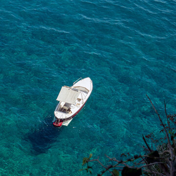 Boat at anchor in the turquoise waters of the Aelian Islands