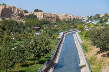 Urban landscaped park with a canal on the outskirts of Samarkand on a sunny day. Uzbekistan - 790258947