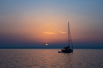 Yacht at anchor  along the West Coast of Sardinia  at sunset