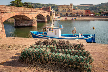 Fishing nets and boat on the shore of the River Tema, Bosa, Sardinia