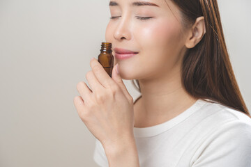 Aromatherapy, pretty asian young woman close her eyes enjoying smell fragrance of herbal from...