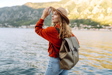 Happy Woman tourist admiring the landscape nature. The concept of travel, vacation. Active...