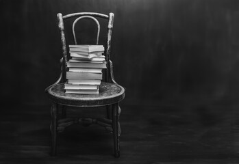 stack of old books on a chair