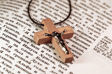 Wooden crucifix with Jesus Christ on the Bible pages