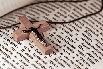 Wooden crucifix with Jesus Christ on the Bible pages