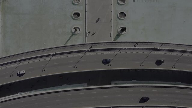 Drone footage of cars driving on bridge, and Hemisferic IMAX theater on a sunny day in Valencia