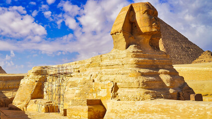 A grand view of the Great Sphinx of Giza with scaffolding for restoration work on a bright hot day...