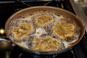 The fried pork chops in a pan
