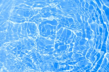 blue water background. texture of blue water surface with waves, splashes, ripples and bubbles....