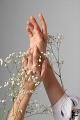 Beautiful female hands with white flowers. Natural cosmetics for hand skin care