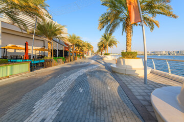 Seaside cafes and shops along the waterfront promenade at the Yas Waterfront district on Yas Island in Abud Dhabi, United Arab Emirates.