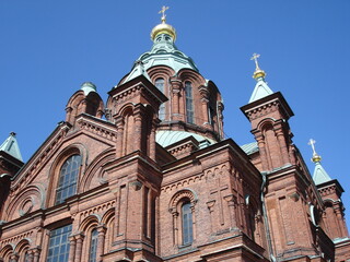 Fototapeta na wymiar An orthodox cathedral in the Baltic States under a deep blue sky.