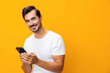 Phone man communication portrait copy smiling studio smartphone cyberspace space mobile happy yellow phone