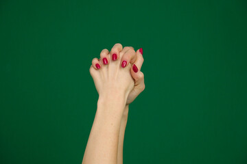 body parts of a young woman on a green background chromakey Hands of the woman expressing the...
