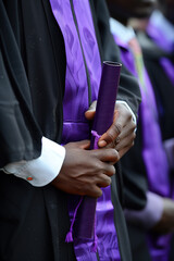 Naklejka premium Close-up of graduates holding diplomas during commencement.