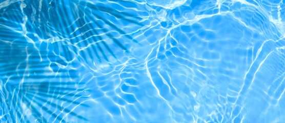 abstract tropical blue water surface with palm tree shadow in summer sunlight. palm shadow on ocean...