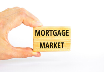Mortgage market symbol. Concept words Mortgage market on beautiful wooden blocks. Beautiful white table white background. Businessman hand. Business mortgage market concept. Copy space.