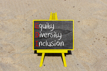 EDI equity diversity inclusion symbol. Concept words EDI equity diversity inclusion on yellow blackboard. Beautiful sand background. Business EDI equity diversity inclusion concept. Copy space.