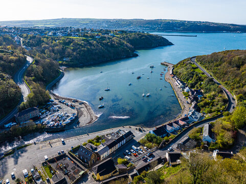 Aerial shot of small fishing village harbour with boats at Fishguard, Pembrokeshire, Wales.