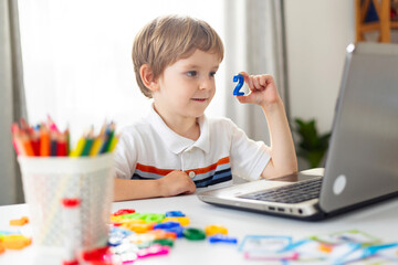 Boy Learning with Laptop and Educational Toys
