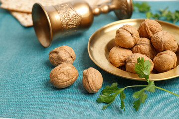 Pesach background. Passover jewish. Matzah, walnuts, parsley on the on the blue background and...