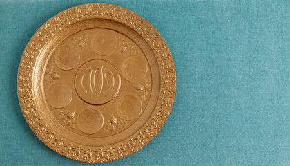 Golden plate for Seder Pesach (Jewish Passover holiday) (with the inscriptions: egg, shankbone, bitter herbs, lettuce, charoset, parsley) Concept (jewish Passover holiday)