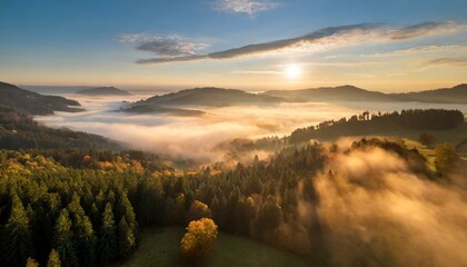 sunrise over the misty mountains
