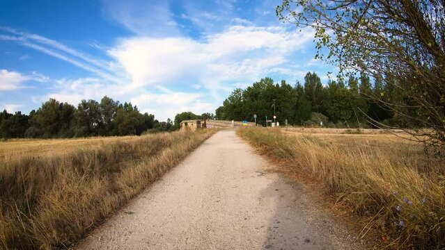 French Way of Saint James - a dirt road at Puente Fitero bridge over Pisuerga river, Itero de la Vega, province of Palencia, Castile and Leon, Spain