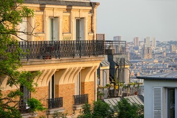 Vue sur un immeuble au coucher du soleil et Paris en arrière plan