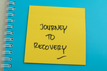 Concept of Journey To Recovery write on sticky notes isolated on Wooden Table.