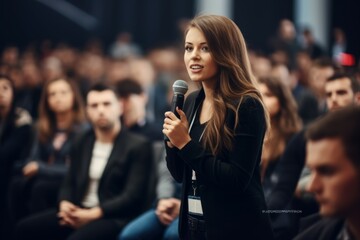 Female manager asking a question from audience while participating in business seminar at convention center, stock photo, realistic photo --ar 3:2 --v 5.2 Job ID: 38aec41f-979d-4675-98ac-496ed73e4a7b