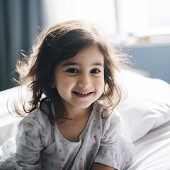 Little girl waking up on bed in the morning