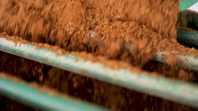 Mixing soil for growing mushrooms.