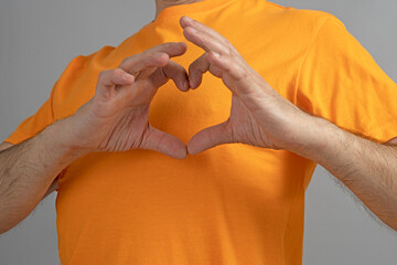 Heart-shaped palms on chest. Heart shaped hand gestures
