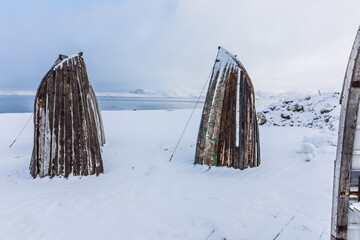 Boat benches on the shore of the Barents Sea in the village of Teriberka, near Murmansk, Russia