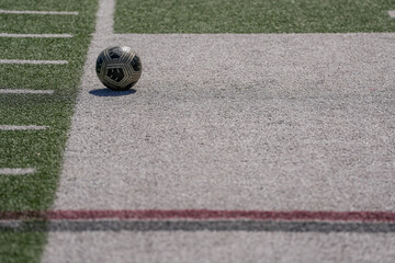 soccer ball isolated outdoors on the field on white chaulk with leading red lines
