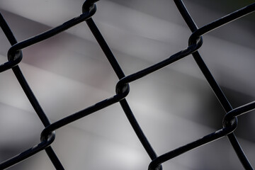 chain link fence up close showing metal and motion in the background